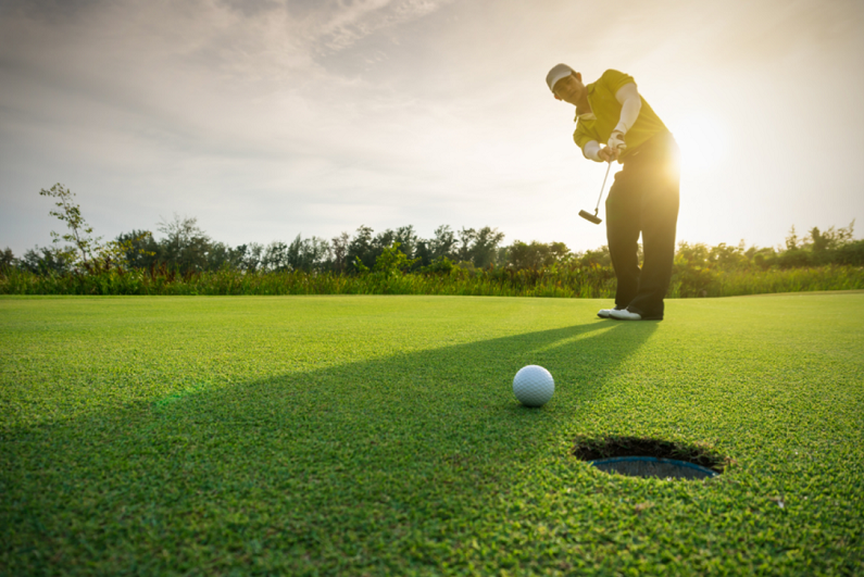 golfer putting golf ball